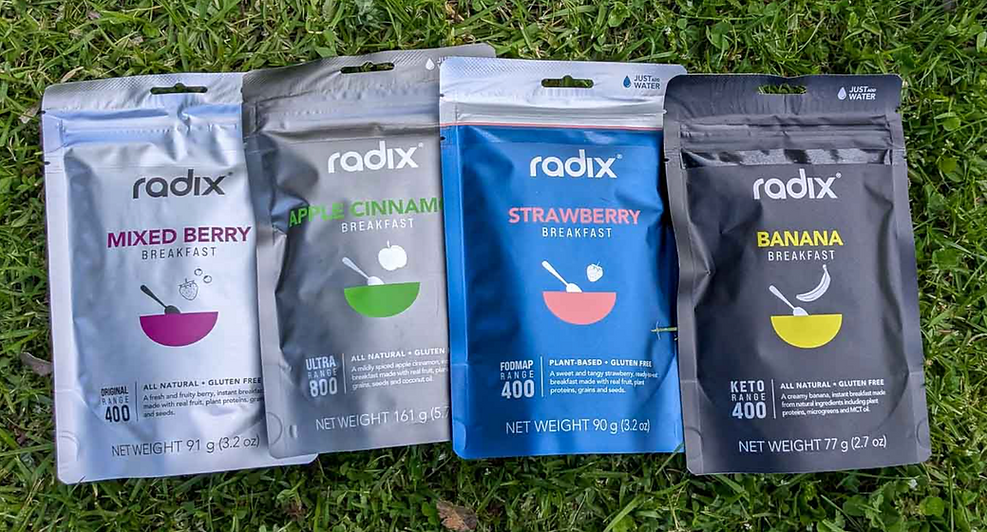 Original, Ultra, Low-FODMAP, and Keto radix meal packets on grass